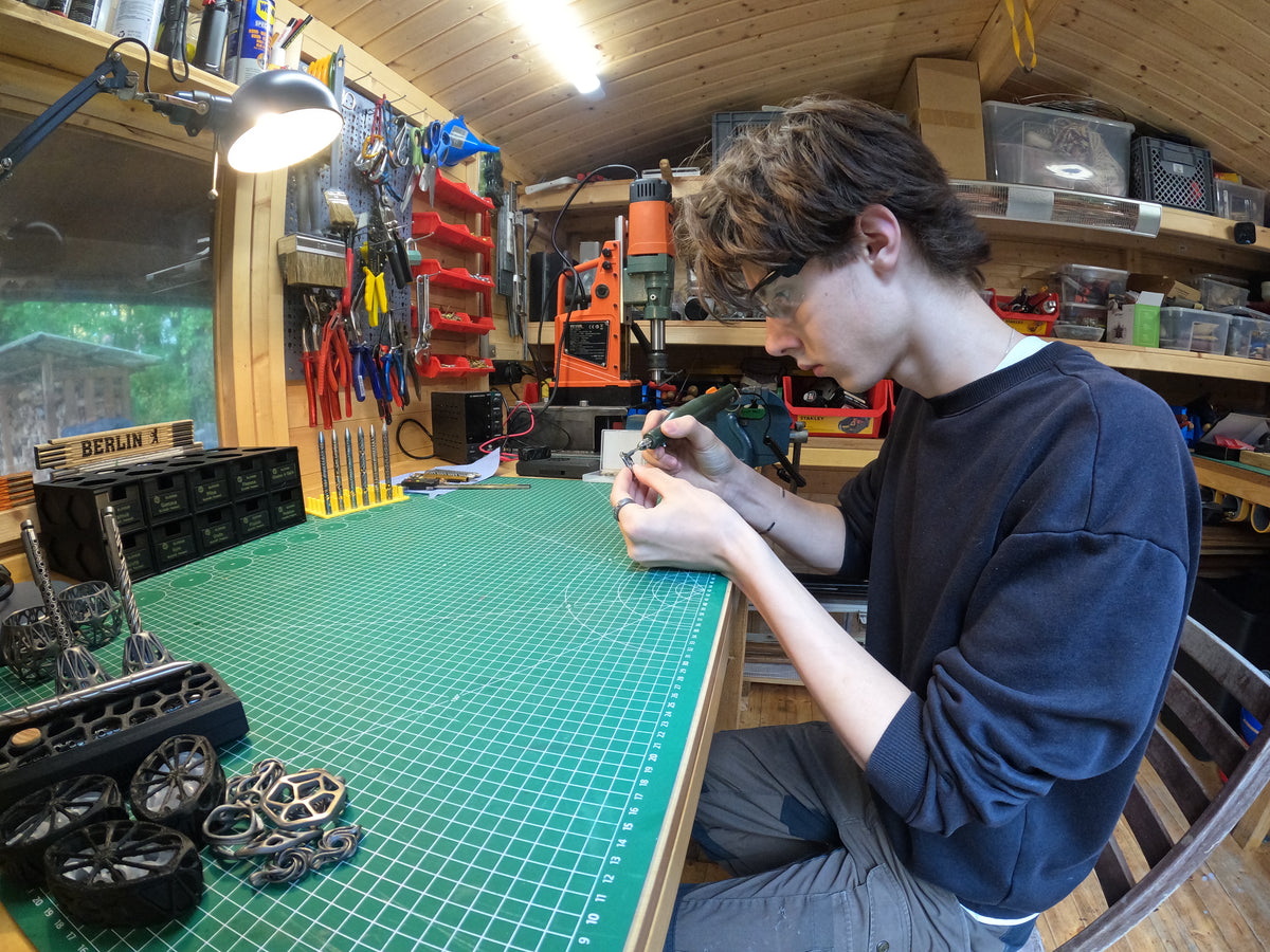 Paul working on a pendant at his jewellery workbench in Berlin
