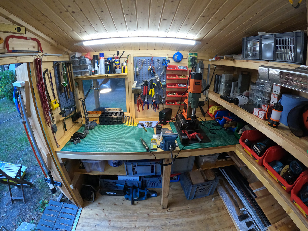 Workbench, hand tools and drill press inside Paul's workshop in Berlin